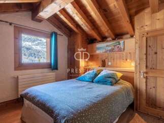 Discover the charm of this cozy bedroom, featuring a stunning wooden ceiling and walls that exude warmth.