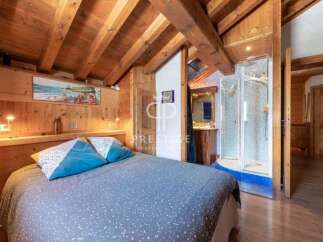 Discover the charm of this cozy bedroom with its rustic wooden beams and inviting ambiance.