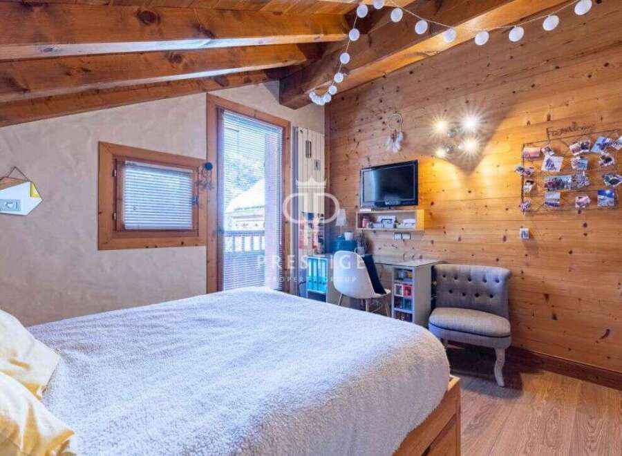Cozy bedroom with wooden accents and a touch of modern design.