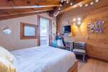 Cozy bedroom with wooden accents and a touch of modern design.