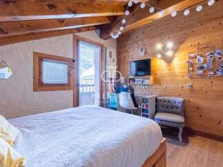 Cozy bedroom with wooden accents and a touch of modern design.