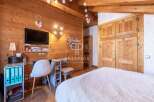 Discover the charm of this cozy bedroom, featuring warm wooden accents and a touch of rustic elegance.