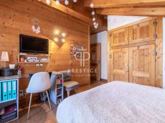 Discover the charm of this cozy bedroom, featuring warm wooden accents and a touch of rustic elegance.