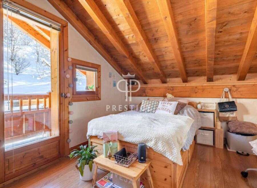 Discover the charm of this cozy bedroom with its wooden accents and inviting atmosphere.