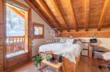 Discover the charm of this cozy bedroom with its wooden accents and inviting atmosphere.