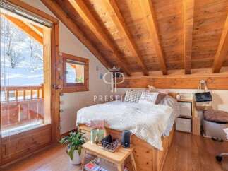 Discover the charm of this cozy bedroom with its wooden accents and inviting atmosphere.