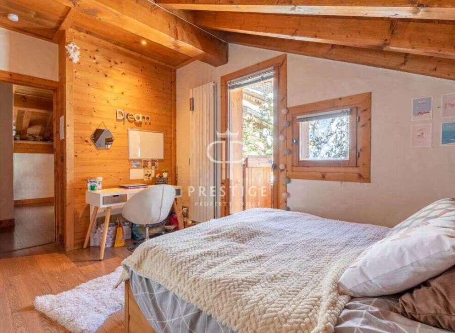 Discover the charm of this cozy bedroom, featuring warm wooden accents and a serene atmosphere.