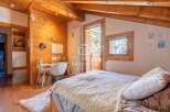 Discover the charm of this cozy bedroom, featuring warm wooden accents and a serene atmosphere.