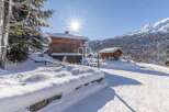 Discover a stunning winter chalet nestled in a picturesque snowy landscape.