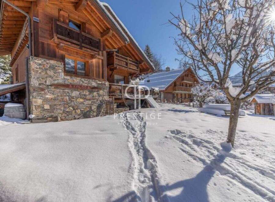 Discover the charm of this stunning wooden chalet nestled in a snowy landscape.