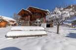 Experience the charm of a snow-covered chalet nestled in a picturesque winter wonderland.