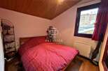 Cozy bedroom with a comfortable bed and a charming red and white patterned duvet.