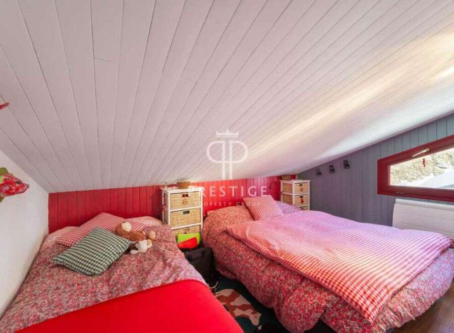 Charming attic bedroom with two beds, perfect for a cozy retreat.