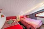 Charming attic bedroom with two beds, perfect for a cozy retreat.