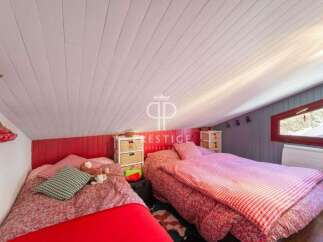 Charming attic bedroom with two beds, perfect for a cozy retreat.