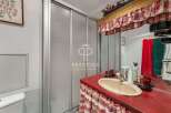 Charming bathroom with a unique red countertop and a stylish sink.