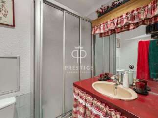 Charming bathroom with a unique red countertop and a stylish sink.