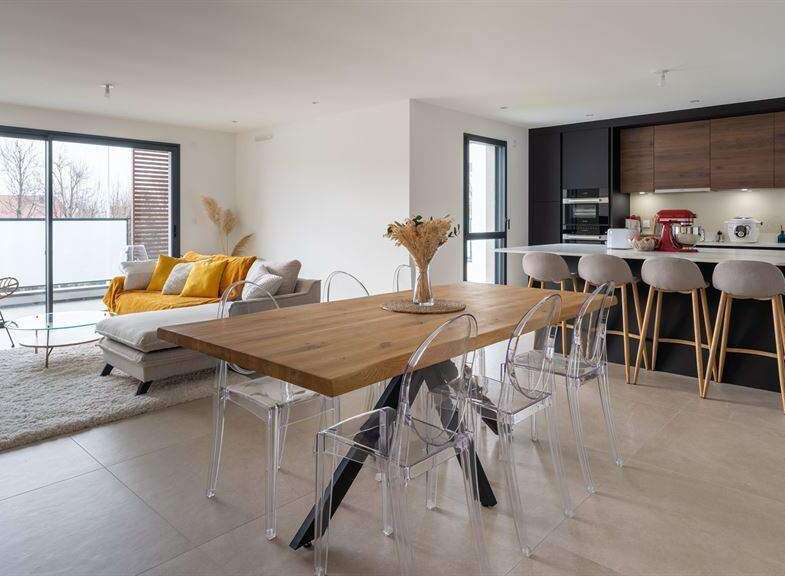 Stunning open-plan living space with floor-to-ceiling windows offering ample natural light.