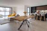 Stunning open-plan living space with floor-to-ceiling windows offering ample natural light.