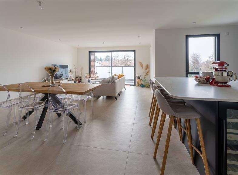 Stunning open-plan living space with sleek modern kitchen and island.