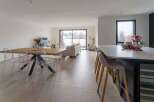 Stunning open-plan living space with sleek modern kitchen and island.