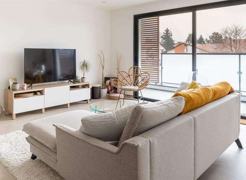 Modern apartment living with stylish furniture and a spacious balcony.
