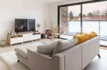 Modern apartment living with stylish furniture and a spacious balcony.