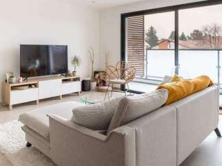 Modern apartment living with stylish furniture and a spacious balcony.