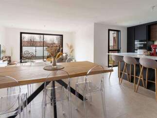 Stunning open-plan living space with a sleek modern kitchen and a large dining table perfect for entertaining.