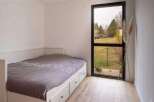 This bright bedroom features a comfortable bed with built-in drawers, perfect for storage.