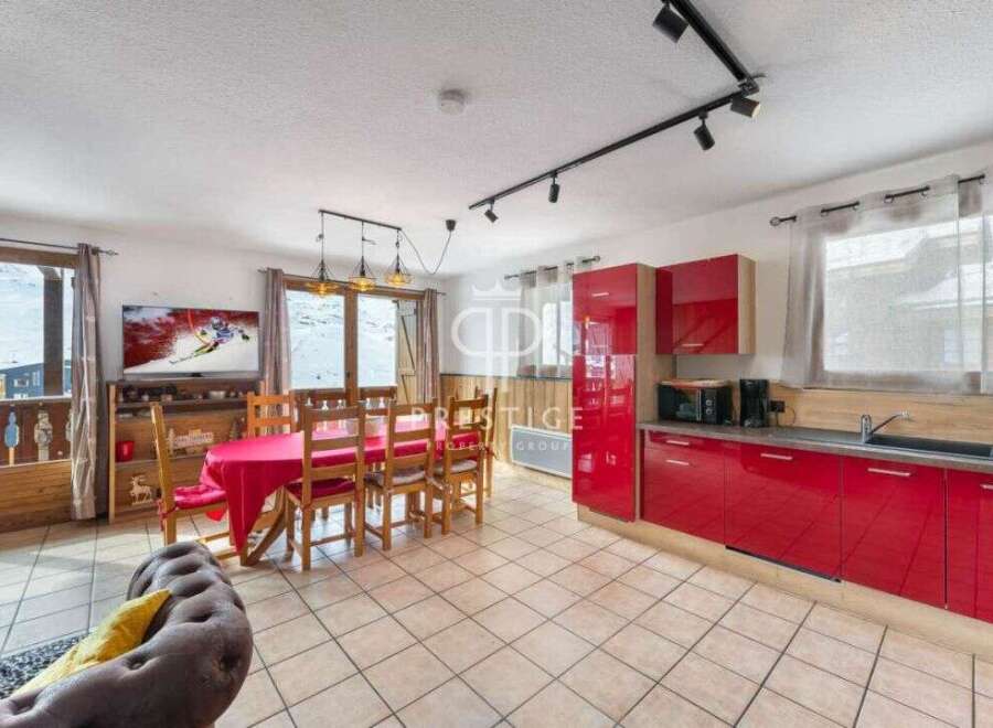 Discover a stunning property with a modern red kitchen, perfect for culinary enthusiasts.