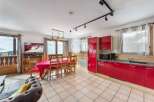 Discover a stunning property with a modern red kitchen, perfect for culinary enthusiasts.