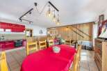 Discover the charm of this stunning property, featuring a vibrant red kitchen and a cozy dining area perfect for gatherings.