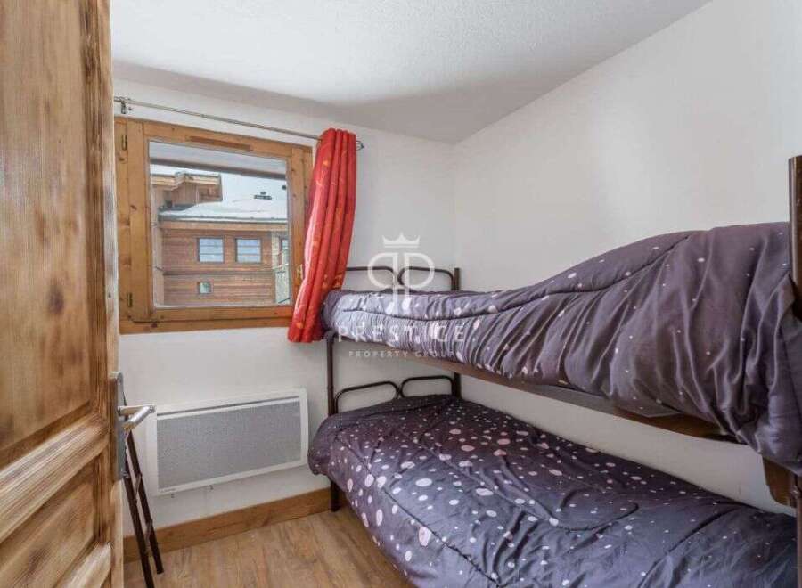 Cozy bedroom featuring bunk beds, perfect for accommodating guests or family.