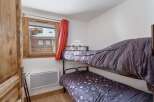 Cozy bedroom featuring bunk beds, perfect for accommodating guests or family.