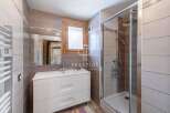 Discover a stylish bathroom featuring a modern vanity and a sleek glass shower enclosure.