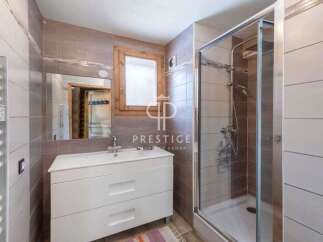 Discover a stylish bathroom featuring a modern vanity and a sleek glass shower enclosure.