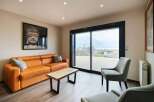 Relax and unwind in this stunning living space, featuring floor-to-ceiling windows showcasing breathtaking mountain views.