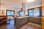 Stunning kitchen with modern gray cabinets and a sleek island, featuring a wine rack and ample counter space.