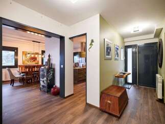 This stunning property boasts a spacious open-plan living area with hardwood floors and a modern kitchen.