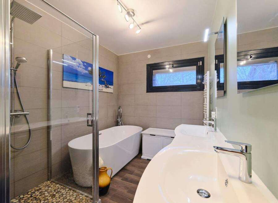 Luxurious bathroom with a walk-in shower, a freestanding bathtub, and double sinks.
