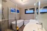 Luxurious bathroom with a walk-in shower, a freestanding bathtub, and double sinks.