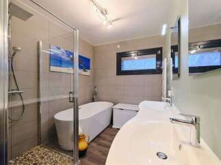 Luxurious bathroom with a walk-in shower, a freestanding bathtub, and double sinks.