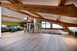 Stunning attic conversion boasts exposed wooden beams and expansive windows offering breathtaking views.