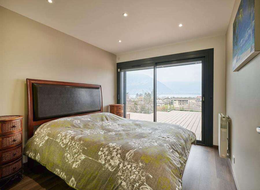 Wake up to breathtaking lake views from this luxurious bedroom.