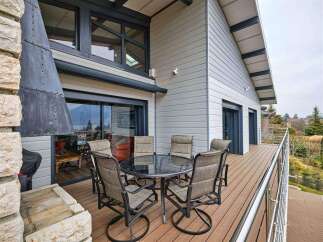 This stunning property boasts a spacious deck with breathtaking views, perfect for outdoor entertaining.