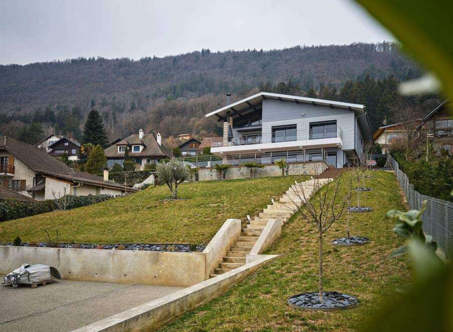 Stunning contemporary home nestled on a hillside, offering breathtaking views.