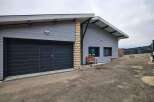Modern house with attached garage and spacious driveway.