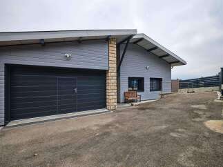 Modern house with attached garage and spacious driveway.