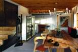 This stunning property boasts a modern dining area with a rustic wooden table and stylish chairs, perfect for entertaining.